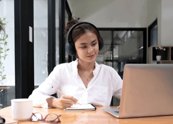 a woman working on laptop on her desk
